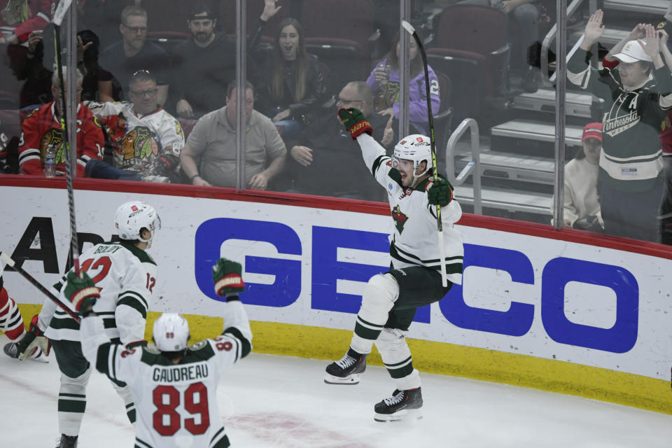 Minnesota Wild's Marcus Johansson (90) right, celebrates with teammates Frederick Gaudreau (89) and Matt Boldy (12) after scoring during the third period of an NHL hockey game against the Chicago Blackhawks, Monday, April 10, 2023. (AP Photo/Paul Beaty)