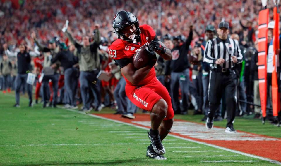 N.C. State’s Jordan Poole (33) runs in on a 12-yard touchdown reception during the first half of N.C. State’s game against Miami at Carter-Finley Stadium in Raleigh, N.C., Saturday, Nov. 4, 2023.