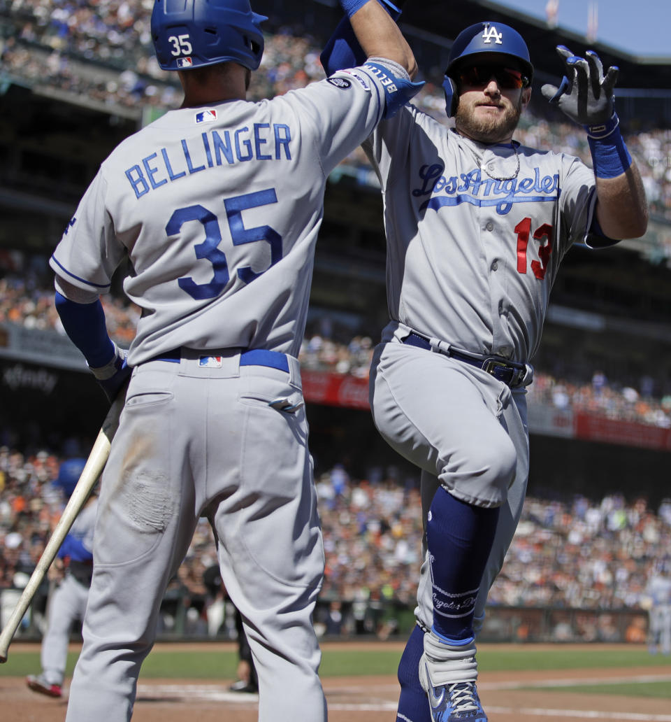 Los Angeles Dodgers' Max Muncy, right, celebrates with Cody Bellinger (35) after hitting a home run off San Francisco Giants' Logan Webb in the sixth inning of a baseball game Saturday, Sept 28, 2019, in San Francisco. (AP Photo/Ben Margot)