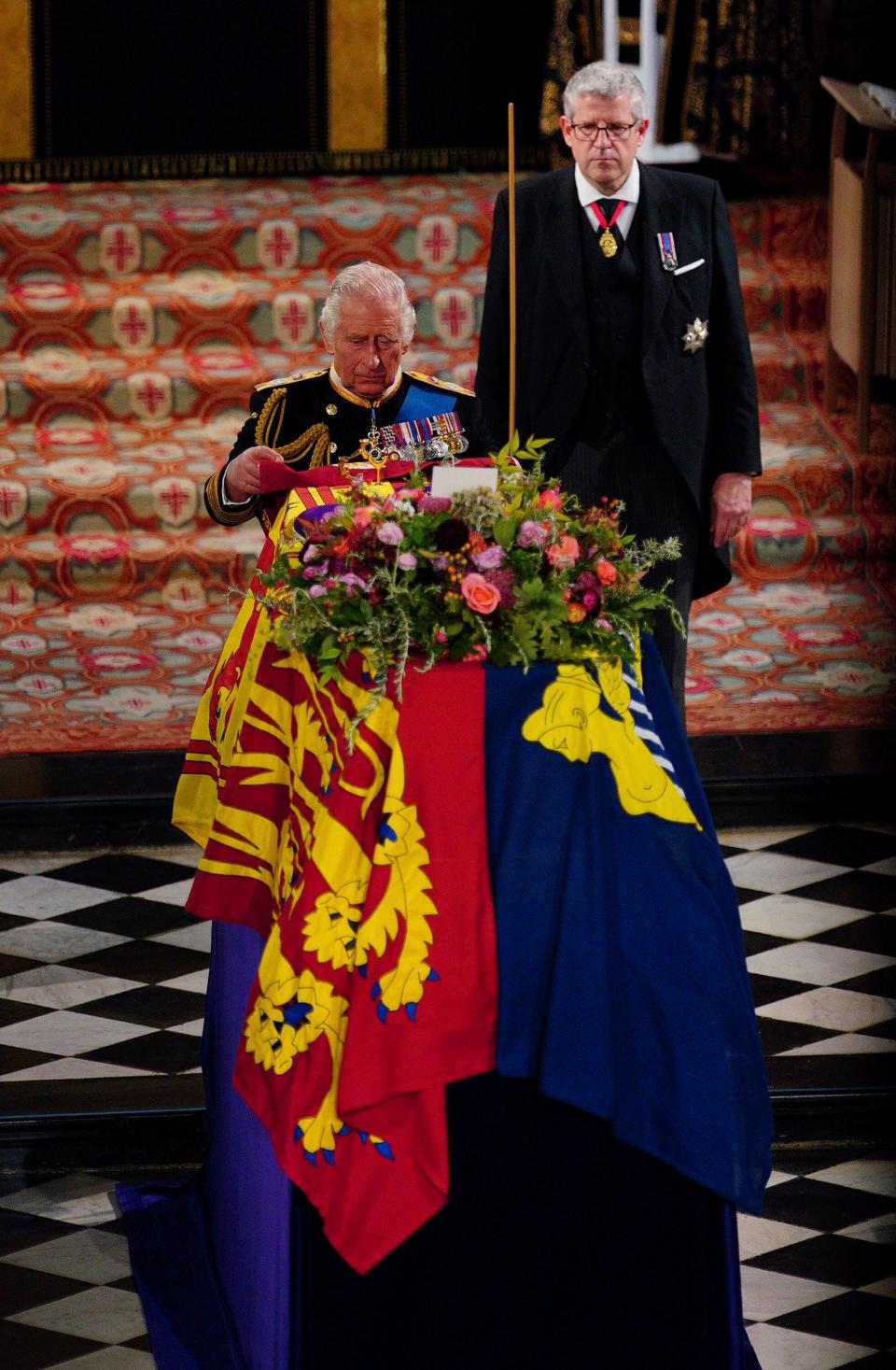 King Charles III places the Queen's Company Camp Colour of the Grenadier Guards on the coffin during the Committal Service for Queen Elizabeth II at St George's Chapel.