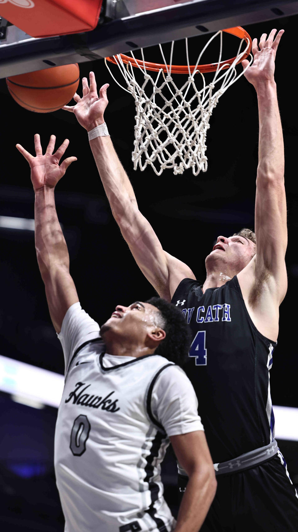 Covington Catholic center Caden Miller (4) blocks a shot by Lakota East guard Trey Perry (0) during their basketball game at the Cintas Center as part of the Hardwood Holiday Classic, Sunday, Jan. 14, 2024.