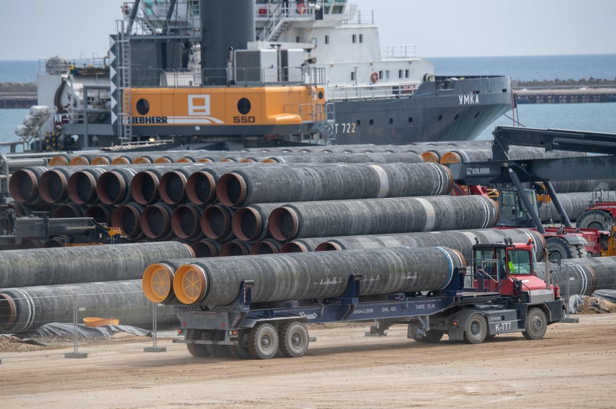 <span class="caption">Pipes for Russia's Nord Stream 2 gas pipeline are loaded onto a ship at a German port, June 1, 2021.</span> <span class="attribution"><a class="link " href="https://www.gettyimages.com/detail/news-photo/june-2021-mecklenburg-western-pomerania-putbus-pipes-for-news-photo/1233216507" rel="nofollow noopener" target="_blank" data-ylk="slk:Stefan Sauer/picture alliance via Getty Images;elm:context_link;itc:0;sec:content-canvas">Stefan Sauer/picture alliance via Getty Images</a></span>