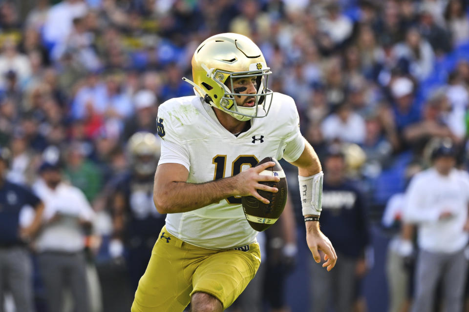 Notre Dame quarterback Drew Pyne (10) runs the ball during the first half of an NCAA college football game against Navy , Saturday, Nov. 12, 2022, in Baltimore. (AP Photo/Terrance Williams)