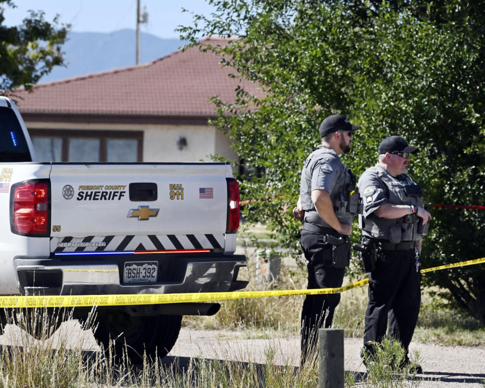 Fremont County deputies guard the road leading to the Return to Nature Funeral Home in Penrose, Colo. Thursday, Oct. 5, 2023. Authorities said Thursday they were investigating the improper storage of human remains at a southern Colorado funeral home that performs “green” burials without embalming chemicals or metal caskets. (Jerilee Bennett/The Gazette via AP) /The Gazette via AP)