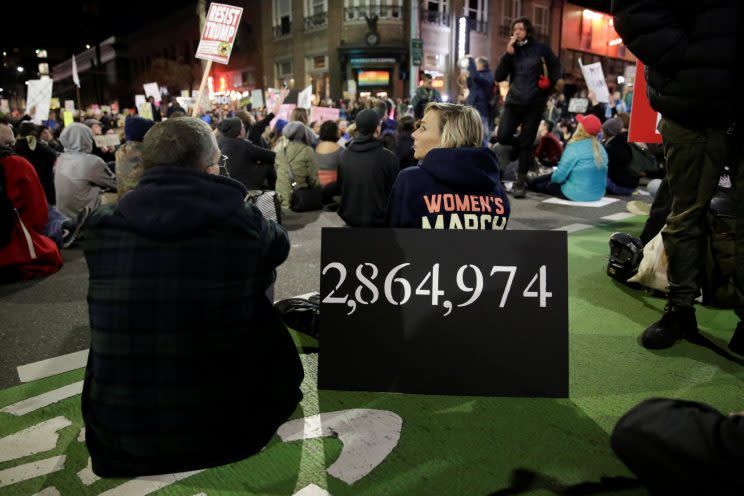 A sign is pictured with the number of how many more votes Hillary Clinton collected than Donald Trump at the Women's March in Seattle on Saturday. (Jason Redmond/Reuters)