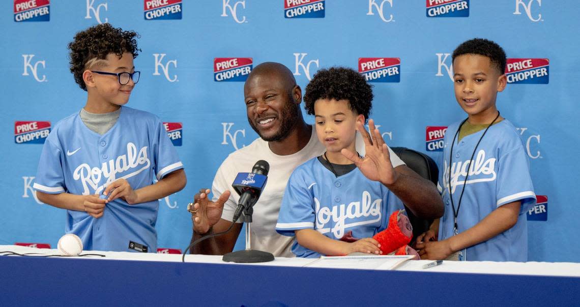 Former Kansas City Royals center fielder Lorenzo Cain smiles after signing a one-day ceremonial contract to retire with the Royals at Kauffman Stadium on Saturday, May 6, 2023, in Kansas City. Cain’s three sons, Cameron, left, Landyn and Jayden joined him for a press conference before the ceremonies.