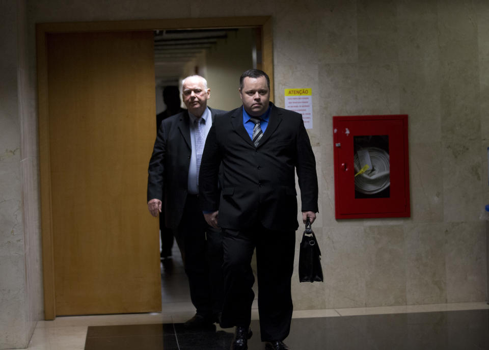 Lawyers Mauricio Eduardo Mayr, right, and Eduardo Mayr, who represent Marcelo Ferreira dos Santos Santoro, walk at the court where a pre-trial hearing is being held for their client in Rio de Janeiro, Brazil, Wednesday, Sept. 19, 2018. A pre-trial hearing was held in the case of Santoro, a Brazilian man charged with killing his former girlfriend in Australia. (AP Photo/Silvia Izquierdo)