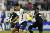 United States' Antonee Robinson (5) controls the ball as he is defended by Canada's Richie Laryea (22) during the second half of a World Cup soccer qualifier Sunday, Sept. 5, 2021, in Nashville, Tenn. (AP Photo/Mark Humphrey)