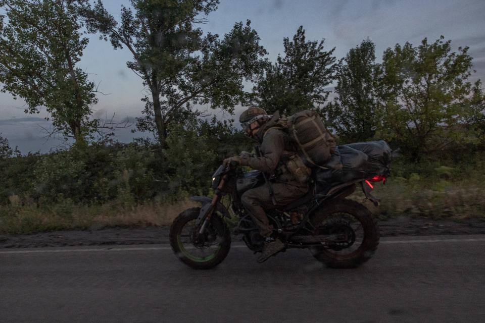 A Ukrainian serviceman rides a motorcycle on a road in the Donetsk region (AFP via Getty Images)