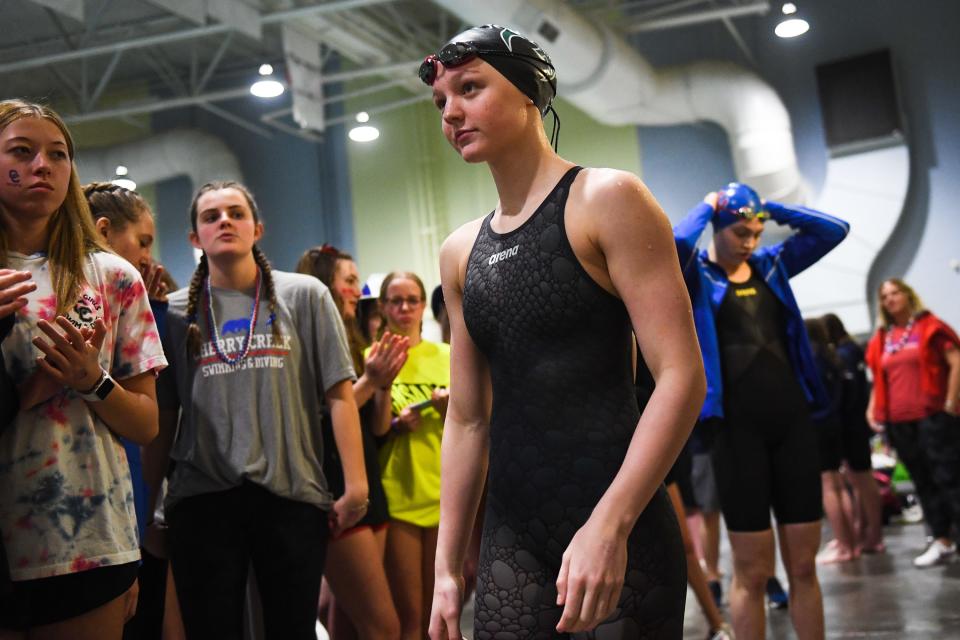 Fossil Ridge swimmer Ella Gaca-Thiele walks toward the podium after taking third place in the 100-yard freestyle at the Colorado Girls 5A State Championships in Thornton on Friday.