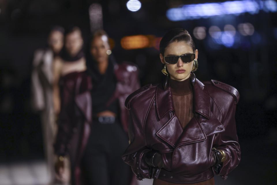 Models wear creations for the Saint Laurent Spring/Summer 2023 fashion collection presented Tuesday, Sept. 27, 2022 in Paris. (Photo by Vianney Le Caer/Invision/AP)