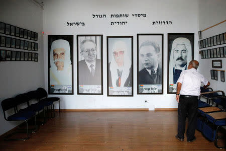 Large portraits of past Israeli and Druze leaders of hang in the hall of remembrance at the town of Daliat al-Karmel with an inscription above that reads "Founders of the shared destiny of Druze and Jews in Israel", in northern Israel August 2, 2018. REUTERS/Amir Cohen