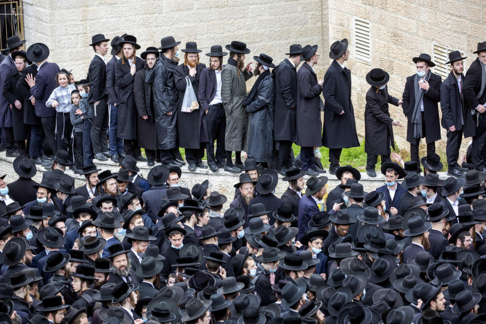 File - In this Sunday, Jan. 31, 2021 file photo, thousands of ultra-Orthodox Jews participate in funeral for prominent rabbi Meshulam Soloveitchik, in Jerusalem. The mass ceremony took place despite the country's health regulations banning large public gatherings, during a nationwide lockdown to curb the spread of the coronavirus. (AP Photo/Ariel Schalit, File)