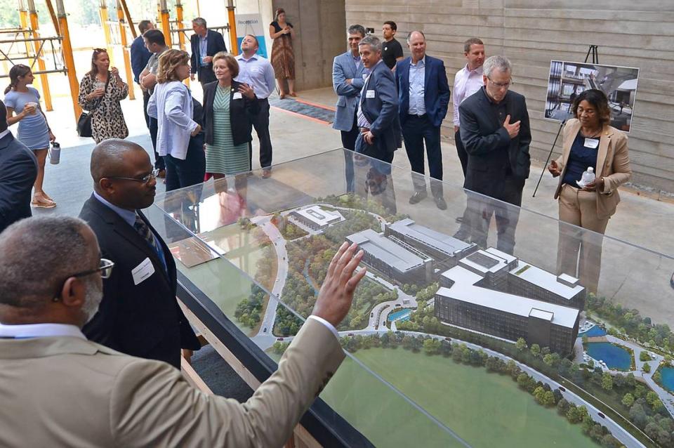 Guests check out the model of Centene Corp. East Coast headquarters campus plans under construction at University City Research Park in Charlotte.