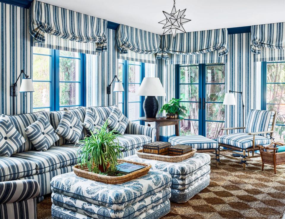 blue patterned living room with sofa and large ottomans