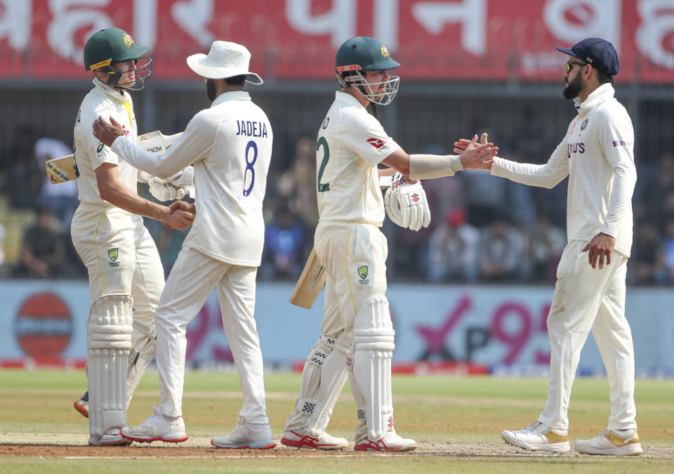 Australia's Marnus Labuschagne, left, and Travis Head, second right, shakes hands with Indian players after Australia won the third cricket test match against India in Indore, India, Friday, March 3, 2023. (AP Photo/Surjeet Yadav)