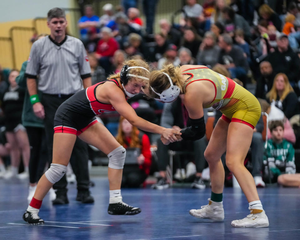 Cedar Falls’s Lauren Whitt, left, wrestles Dallas Center-Grimes’s Ava Gannon at 105 pounds during the championship round of the IGHSAU Regional Qualifier 3 at HyVee Hall on Friday, Jan. 27, 2023. Whitt defeated Gannon with a 5-1 decision.