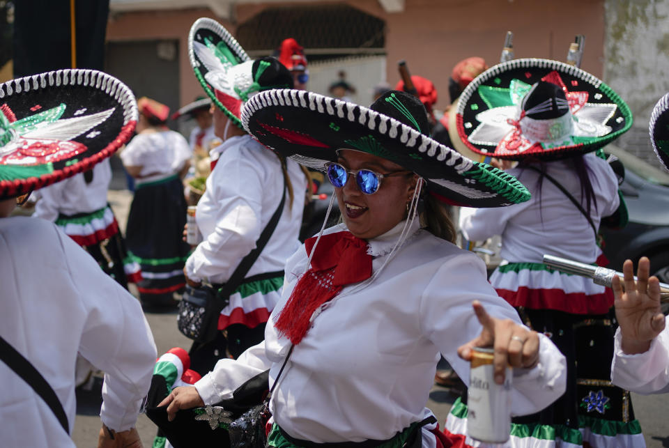 Women dance during a re-enactment of The Battle of Puebla as part of Cinco de Mayo celebrations in the Peñon de los Baños neighborhood of Mexico City, Thursday, May 5, 2022. Cinco de Mayo commemorates the victory of an ill-equipped Mexican army over French troops in Puebla on May 5, 1862. (AP Photo/Eduardo Verdugo)