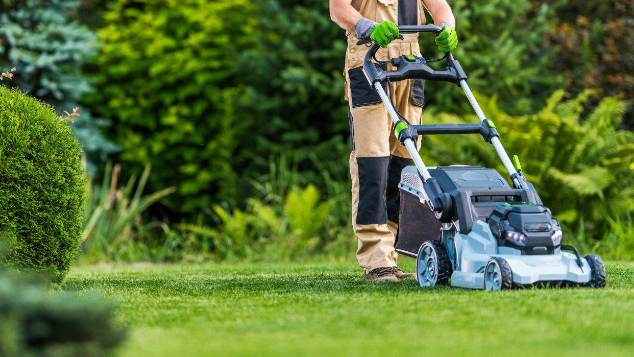  Man mowing lawn. 