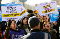 Protesters shout slogans during a protest against a proposal that would have allowed sentencing in cases of sexual abuse committed "without force, threat or trick" before Nov. 16, 2016 to be indefinitely postponed if the perpetrator marries the victim, in front of the Turkish Parlaiment in Ankara, Turkey, November 22, 2016. Banners read, "if the rape will be legitimized the rebellion will go on" (L) and "the bill will be asked from rapist AK Party (AKP) by women (R)" REUTERS/Umit Bektas