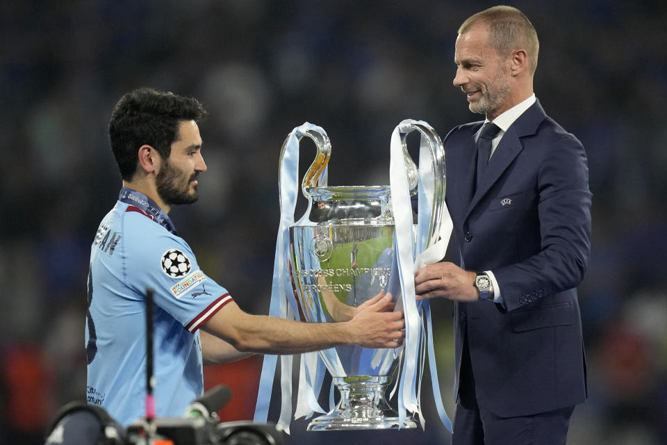 FILE - UEFA president Aleksander Ceferin hands the trophy to Manchester City's team captain Ilkay Gundogan after the the Champions League final soccer match between Manchester City and Inter Milan in Istanbul, Turkey, Sunday, June 11, 2023. The European Union’s top court has ruled UEFA and FIFA acted contrary to EU competition law by blocking plans for the breakaway Super League. The case was heard last year at the Court of Justice after Super League failed at launch in April 2021. UEFA President Aleksander Ceferin called the club leaders “snakes” and “liars.” (AP Photo/Francisco Seco, File)