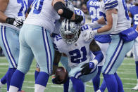 Dallas Cowboys running back Ezekiel Elliott (21) is congratulated by teammate after scoring a touchdown against the New York Giants during the first quarter of an NFL football game, Sunday, Dec. 19, 2021, in East Rutherford, N.J. (AP Photo/Seth Wenig)