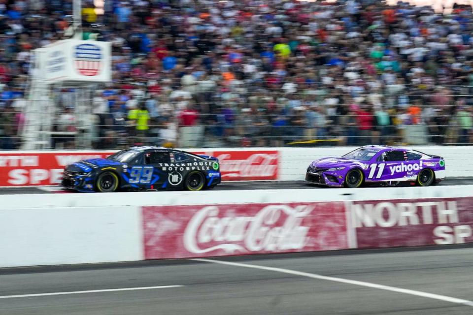 May 21, 2023; North Wilkesboro, North Carolina, USA; NASCAR Cup Series driver Daniel Suarez (99) and driver Denny Hamlin (11) race early on during the All Star Race at North Wilkesboro Speedway.