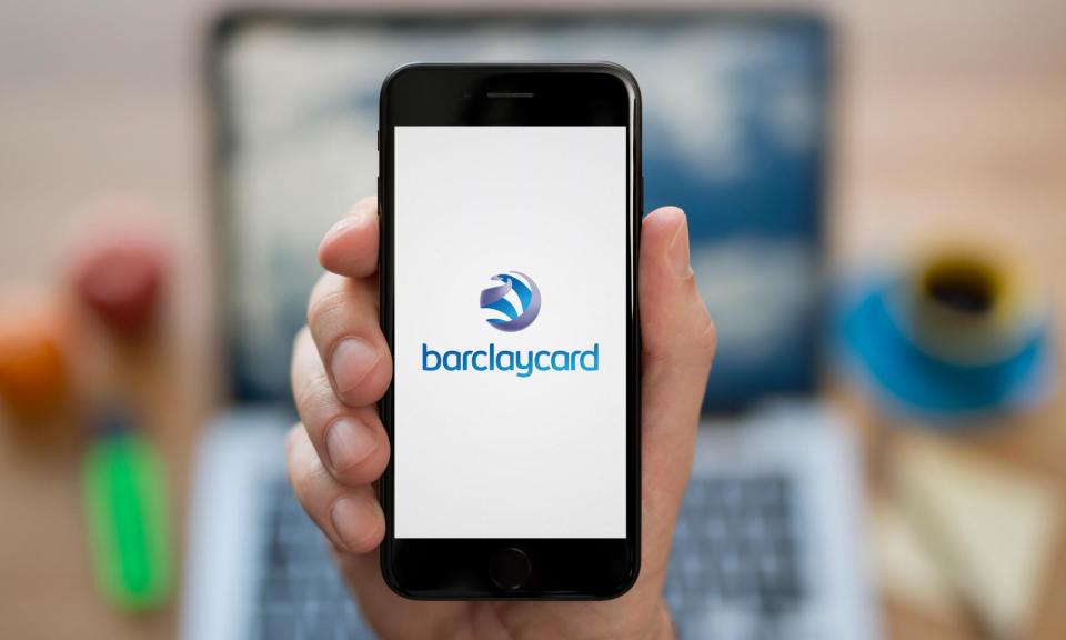 <span>A man looks at his iPhone which displays the Barclaycard logo</span><span>Photograph: M4OS Photos/Alamy</span>