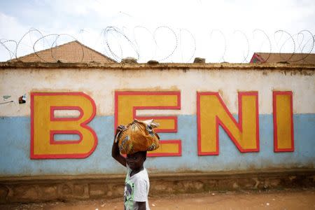 FILE PHOTO: A Congolese boy walks past a wall near the Alima Ebola treatment centre in Beni, in the Democratic Republic of Congo, April 1, 2019. Picture taken April 1, 2019.REUTERS/Baz Ratner/File Photo