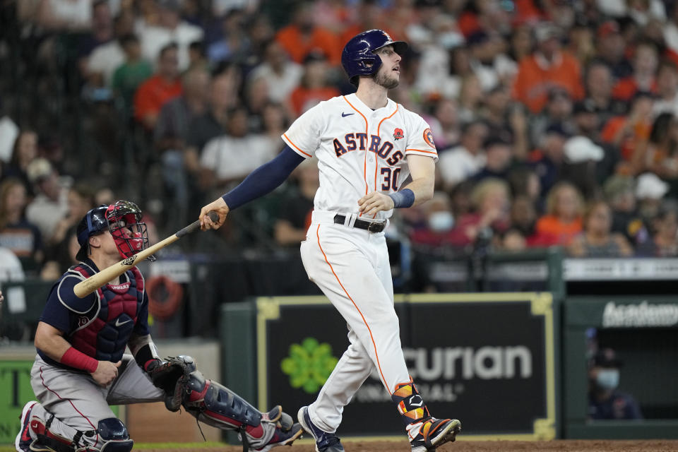 Houston Astros' Kyle Tucker (30) hits a two-run single as Boston Red Sox catcher Christian Vazquez watches during the sixth inning of a baseball game Monday, May 31, 2021, in Houston. (AP Photo/David J. Phillip)