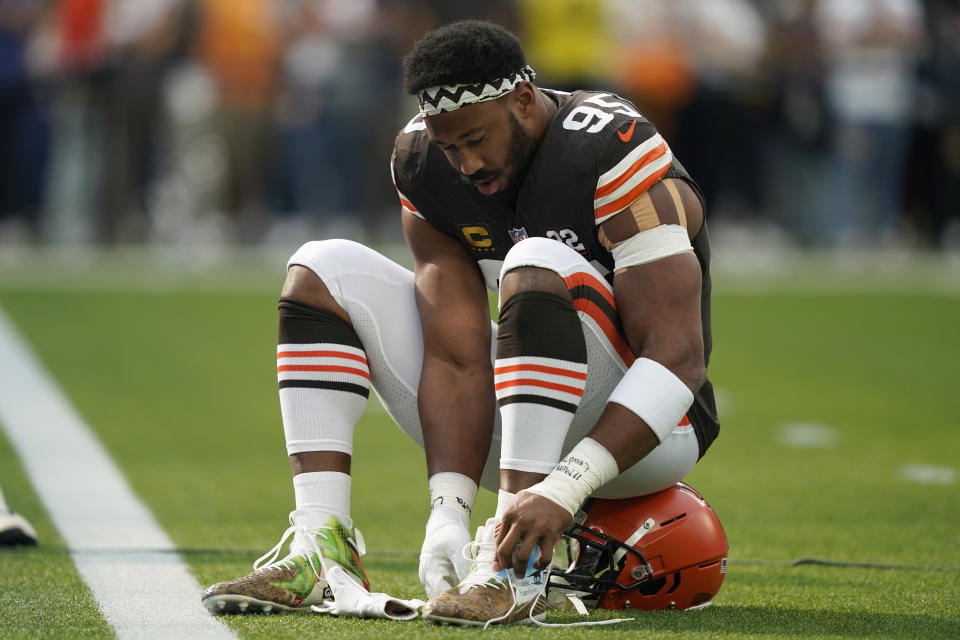 Cleveland Browns defensive end Myles Garrett ties his cleats before an NFL football game against the Los Angeles Rams, Sunday, Dec. 3, 2023, in Inglewood, Calif. (AP Photo/Ryan Sun)