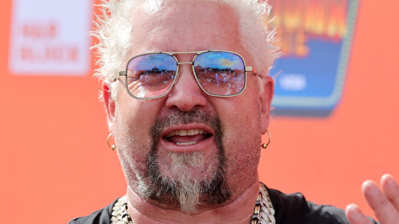 Guy Fieri with a pile of money