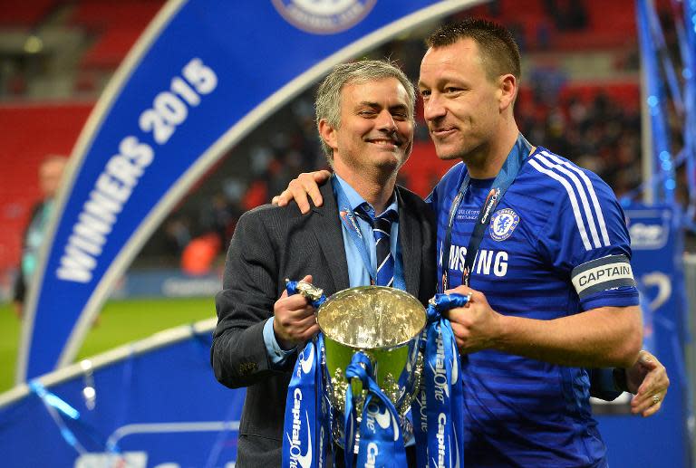 Chelsea's manager Jose Mourinho (L) and captain John Terry celebrate with the trophy, after Chelsea won the League Cup final against Tottenham Hotspur, 2-0, at Wembley Stadium in London, on March 1, 2015