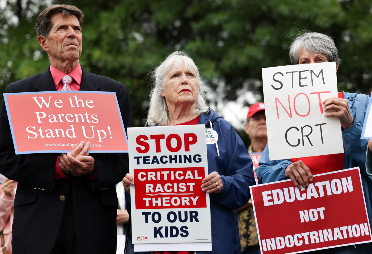 Opponents of the academic doctrine known as critical race theory hold protest signs outside of the Loudoun County School Board headquarters, in Ashburn, Va. 