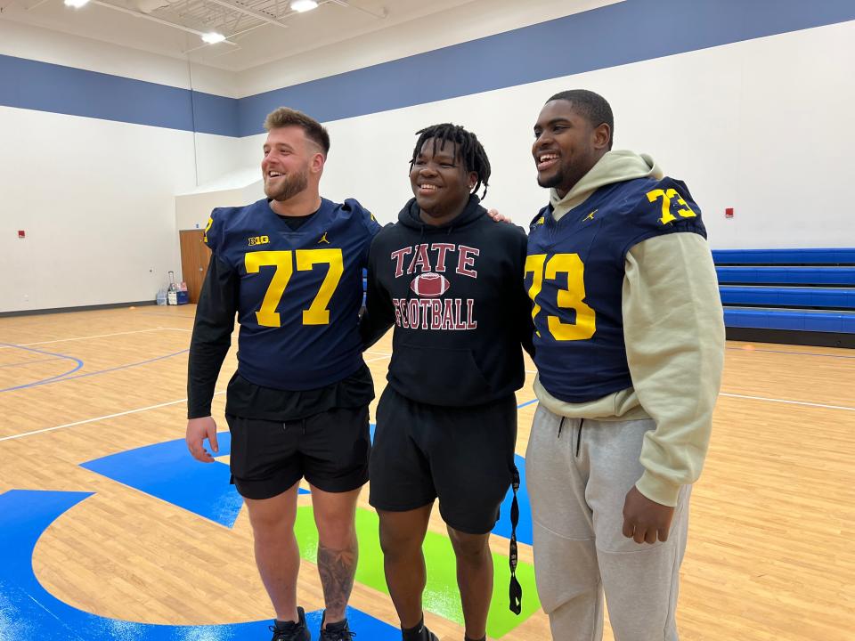Tate defensive end Trevarius Edwards (middle) shares fun moment with Michigan Wolverines offensive linemen Trevor Keegan (77) and LaDarius Henderson (73) during a visit by Reese's Senior Bowl players to Pensacola's Gateway Church of Christ on Wednesday, Jan. 24, 2024.
