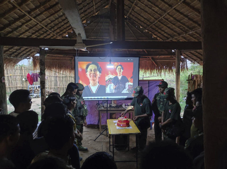 In this photo provided by Thabeikkyin Township People’s Defense Force, the group's members celebrate the 79th birthday of the country’s ousted leader Aung San Suu Kyi with a cake in a hut of the group’s outpost in Thabeikkyin township in Mandalay region, Myanmar, Wednesday, June 19, 2024. (Thabeikkyin Township People’s Defense Force via AP)