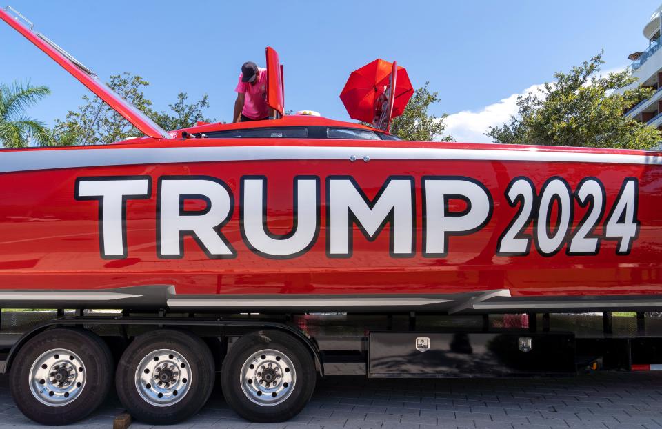 A crew prepares the 52-foot Mystic catamaran emblazoned with Trump 2024 parked outside race headquarters at the Ben hotel on June 7, 2024 in West Palm Beach, Florida. Roger Norman and Nigel Cook will pilot the boat during the Ocean Cup 2024. The 128-mile race from Palm Beach to West End, Bahamas and back is Saturday.