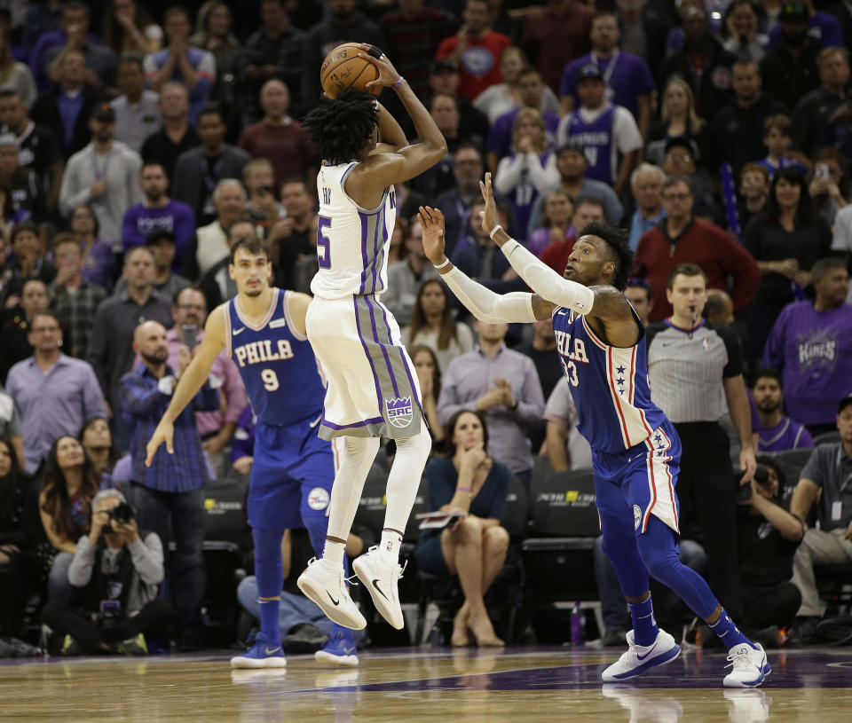 Kings rookie De’Aaron Fox raises up over Robert Covington to deliver the dagger that knocked off the Sixers. (AP)