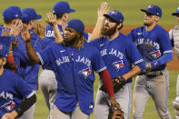 Toronto Blue Jays Vladimir Guerrero Jr. and pitcher Jordan Romano celebrates with their teammates after defeating the Miami Marlins 3-1, during a baseball game, Wednesday, June 23, 2021, in Miami. (AP Photo/Marta Lavandier)