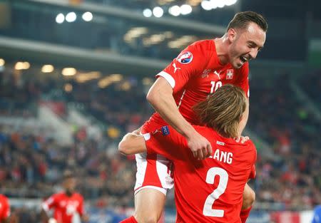 Switzerland's Michael Lang (R) celebrates his goal with team mate Josip Drmic during their Euro 2016 Group E qualifying soccer match against San Marino's in St. Gallen, Switzerland October 9, 2015. REUTERS/Arnd Wiegmann