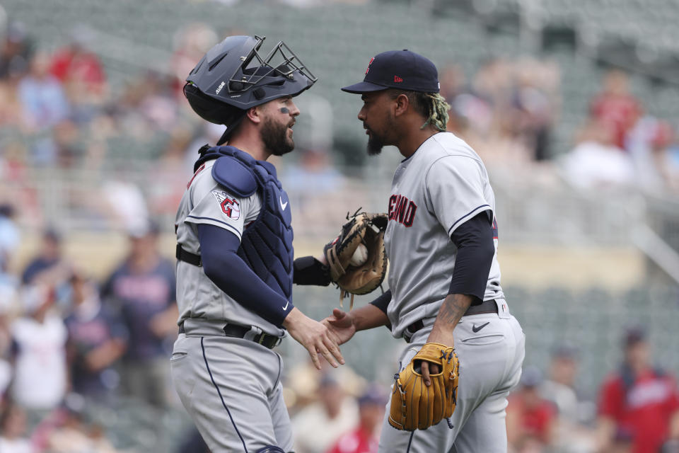 Cleveland Guardians pitcher Emmanuel Clase, right, celebrates with catcher Cam Gallagher, left, after defeating the Minnesota Twins in a baseball game Sunday, June 4, 2023, in Minneapolis. (AP Photo/Stacy Bengs)