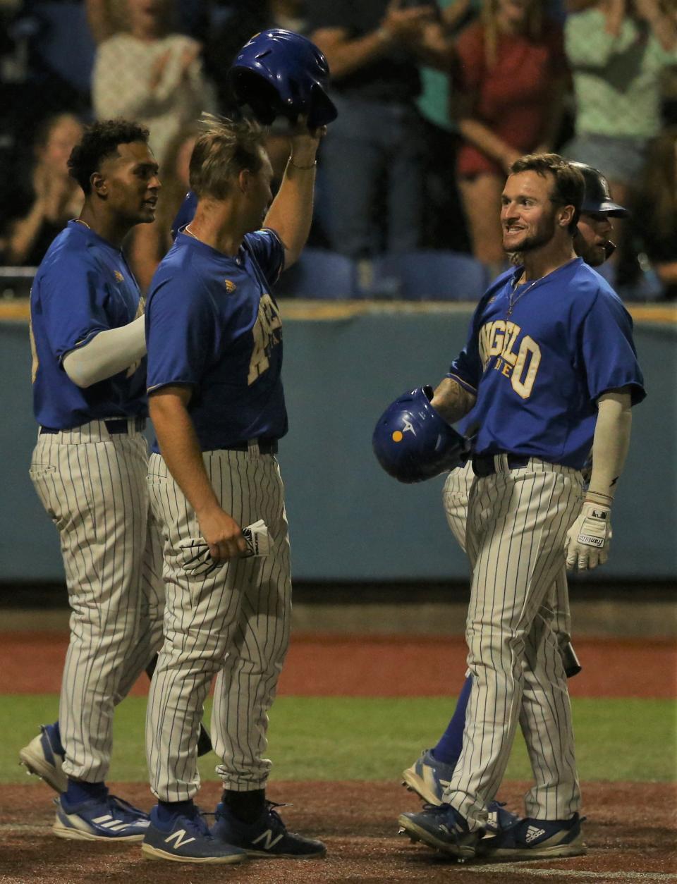 Angelo State University's Justin Lee, far right, is congratulated by teammates after hitting a two-run home run against Colorado Mesa during Game 1 of an NCAA D-II South Central Super Regional at Foster Field at 1st Community Credit Union Stadium on Friday, May  27, 2022.