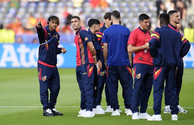 Spain’s Lamine Yamal (left) speaking to Ferran Torres