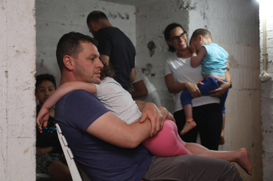 Image: People take shelter in the basement of a building in the Israeli coastal city of Tel Aviv in the early hours of May 13, 2021, after rockets were launched towards Israel from the Gaza Strip. (Gideon Markowicz / AFP - Getty Images)