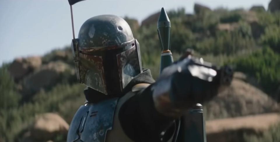 Boba Fett pointing his arm cannon at someone in "The Mandalorian"