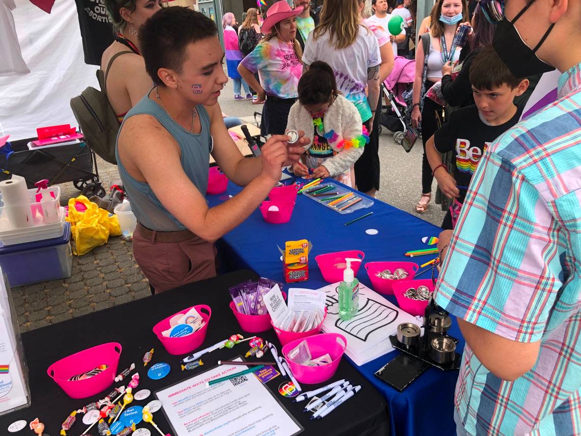 Visitors make their own buttons at the Planned Parenthood booth at the Bellingham Pride Festival on Sunday, July 17, at Depot Market Square.