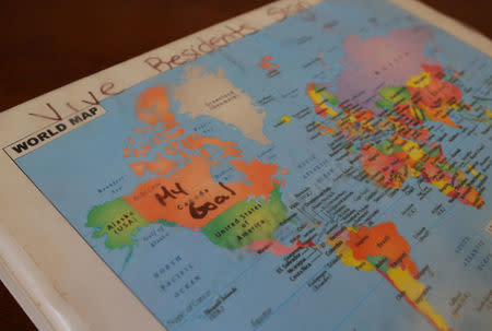 A map of the world, with "My Goal" written in ink over Canada, is seen on the residents' sign-in binder at Vive La Casa shelter in Buffalo, New York, U.S. July 5, 2017. Picture taken July 5, 2017. REUTERS/Chris Helgren