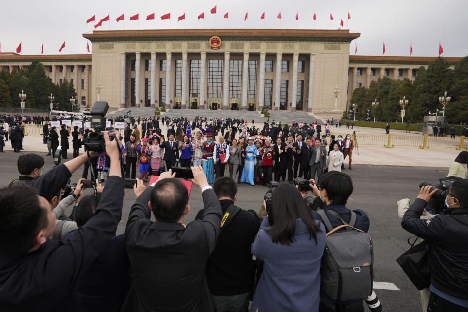 Ethnic minority delegates leave after the closing ceremony for China's National People's Congress (NPC) at the Great Hall of the People in Beijing, Monday, March 13, 2023. (AP Photo/Andy Wong)