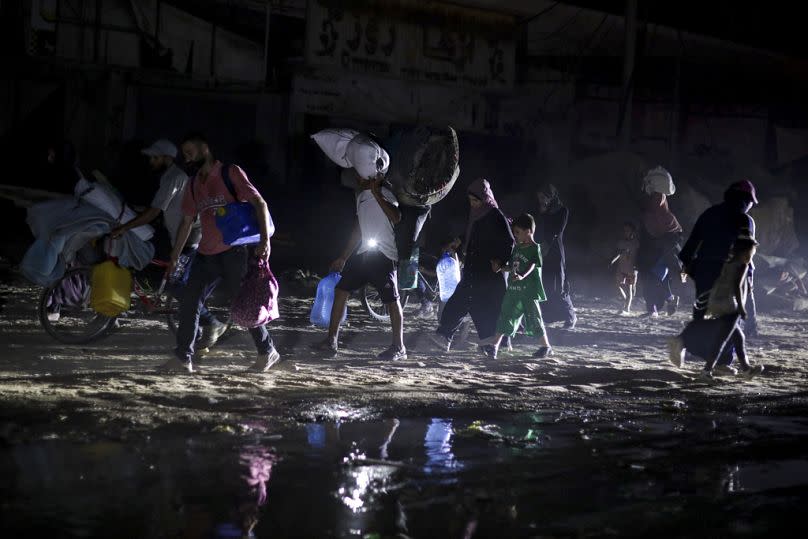 Palestinians displaced by the Israeli air and ground offensive on the Gaza Strip flee from parts of Khan Younis, 1 July 2024