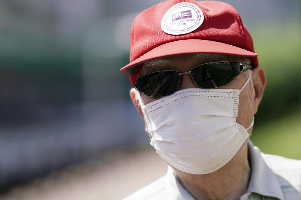 Hidekazu Tamura, 99, wears a protective face mask against coronavirus and a sunglass and a cap against intense sun as he takes a walk as a daily routine in Tokyo Friday, Aug. 28, 2020. Amid commemorations for Wednesday's 75th anniversary of the formal Sept. 2 surrender ceremony that ended WWII, Tamura, a former Japanese American living in California, has vivid memories of his time locked up with thousands of other Japanese-Americans in U.S. intern camps. Torn between two warring nationalities, the experience led him to refuse a loyalty pledge to the United States, renounce his American citizenship and return to Japan.(AP Photo/Eugene Hoshiko)